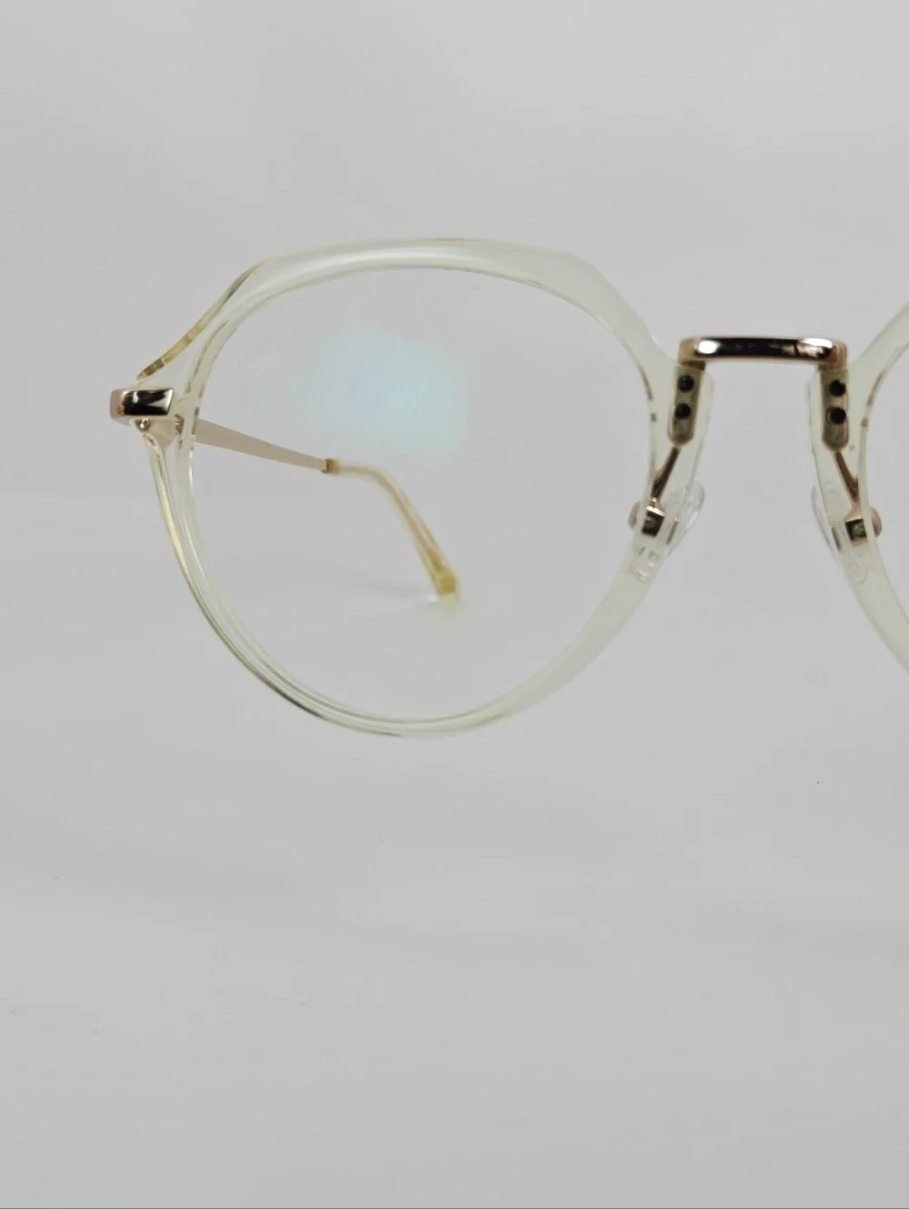 Tamara. Clear Round Frame Glasses. All Gold Accents are Metal.